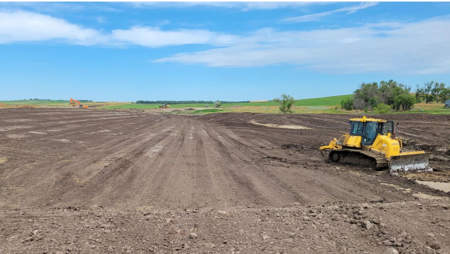 yellow tractor doing land grading 1